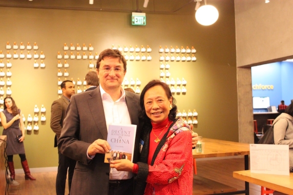 Chris Ruffle poses with a guest after signing his memoir, A Decent Bottle of Wine in China (Ranna Iglesias Asia Society).