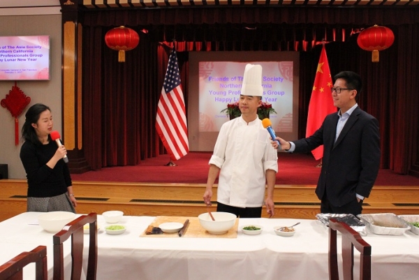 Consul Li Yi and Consul 'Felix' Feng assist the chef during the dumpling cooking demonstration. (Natasha Cheng/Asia Society) 