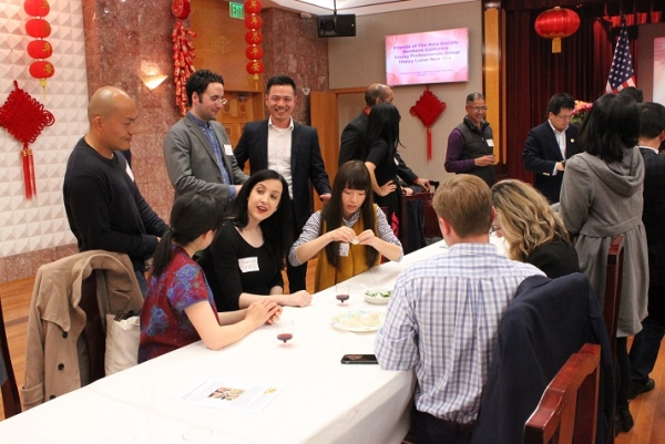 Members mingle while rolling dough and assembling dumplings. (Natasha Cheng/Asia Society) 