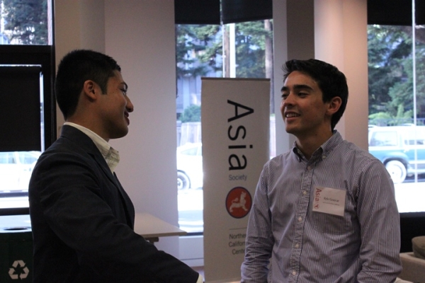 Kyle Graycar (right), ASNC Sustainability Consultant, pauses for a moment to chat with an attendee. (Asia Society) 