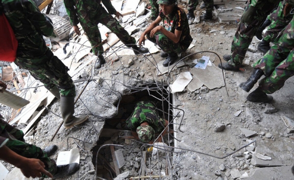 Indonesian soldiers excavate into the wreckage of a building to search for victims and survivors in Padang, Sumatra, on October 1, 2009, following a massive earthquake. (Adek Berry/AFP/Getty Images)