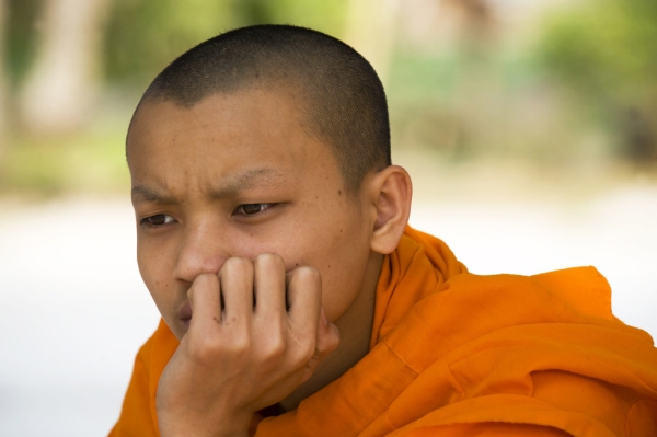A Buddist monk contemplates life at dawn in Luang Prabang, Laos, on April 12, 2009. (Nancy A. Scherl)