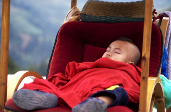 A baby naps in his shoulder-held carriage while parked at the Dragon Spine Rice Terraces in Guilin, China on September 22, 2008. (Nancy A. Scherl)
