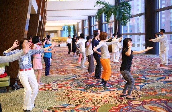 Conference attendees learn Tai Chi before the day's programs begin. (David Keith/David Keith Photography)