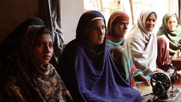 Participants in a women's rights workshop listen to a song by Rani Shameem Akhtar in Malival, Punjab. (Andreas Burgess)