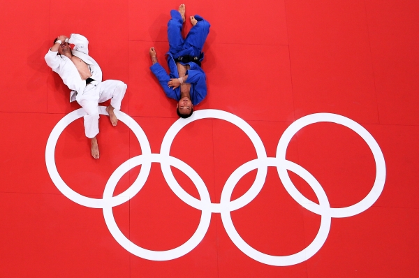 Pawel Zagrodnik of Poland (white) and Masashi Ebinuma of Japan (blue) on the mat after their match in the Men's 66 kg Judo on July 29, 2012. (Ian Walton/Getty Images)