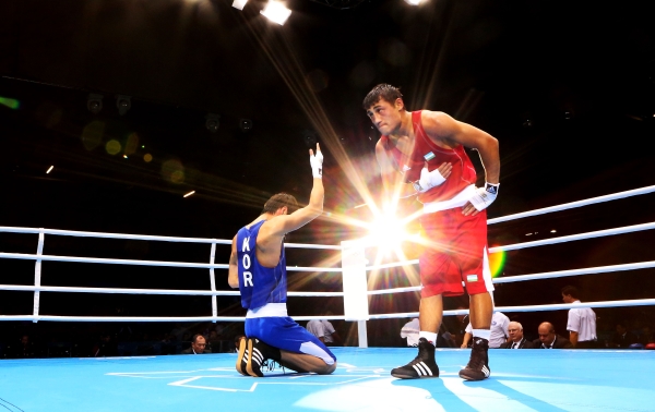 Han Soonchul of Korea (L) celebrates his victory over Fazliddin Gaibnazarov of Uzbekistan (R) during the Men's Light 60kg Boxing on August 6, 2012. (Scott Heavey/Getty Images)