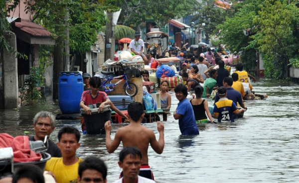 Residents of the town of San Pedro, Laguna province, south of Manila in the Philippines on September 30, 2009 scramble to leave their flooded houses in anticipation of another typhoon that may add to the devastation of a killer storm, the country&apos;s worst in 40 years, that affected over 2.2 million people. (Ted Aljibe/AFP/Getty Images)