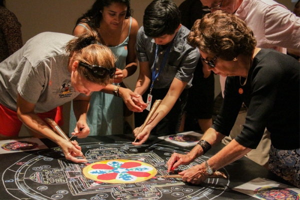 Guests were also able to try their hands at using the chakpur, the tool monks use to funnel sand onto the mandala, by contributing to a Texas-themed mandala. (Nikki Tripp)