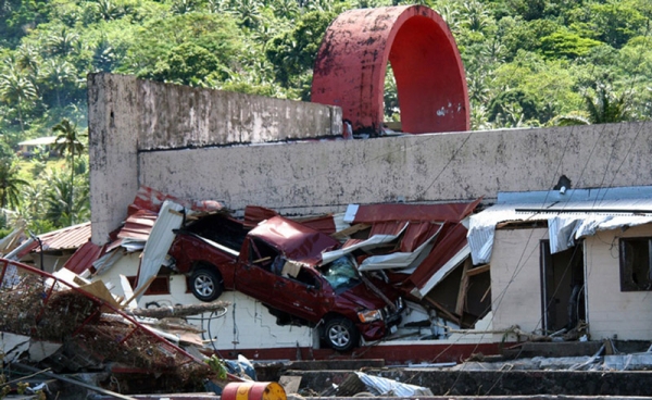 A truck and building are damaged in Pago Pago, American Samoa, on September 29, 2009, after an 8.0 earthquake churned up a giant tsunami that devastated the Samoa islands. (John Newton/AFP/Getty Images)