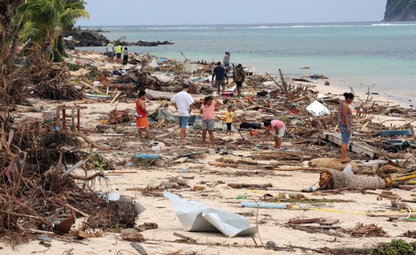 Survivors search for victims amongst the debris left by the tsunami on Lalomanu Beach on the south coast of Samoa on September 30, 2009. (Torsten Blackwood/AFP/Getty Images)