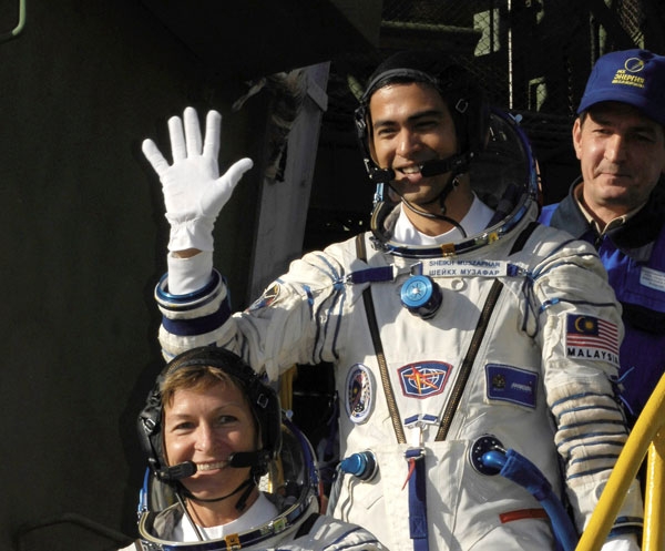 See ya later! Malaysian spaceflight participant Sheikh Muszaphar Shukor waves farewell at the steps of the Soyuz rocket. (Bill Ingalls/NASA/Flickr)