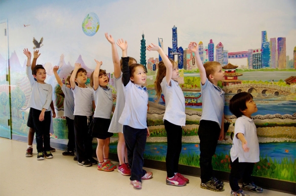 Local and Chinese scenery are combined in volunteer-painted “We Are Yinghua,” a mural funded through the Metropolitan Regional Arts Council. (Erin Spector/Yiinghua Academy)