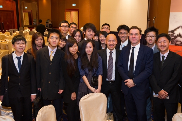 Ferguson poses with a group of local students who attended the dinner. (Asia Society Hong Kong Center)