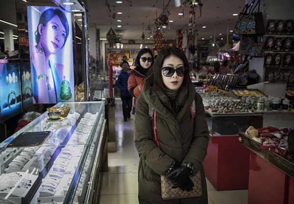 Chinese shoppers walk through a small department store in a shopping district in central Beijing, China. (Kevin Frayer/Getty Images)