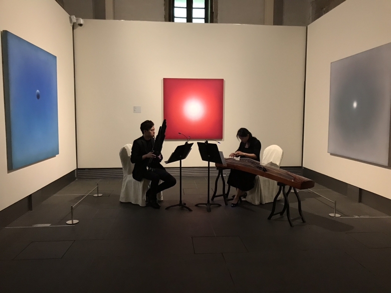 Musicians playing in an art gallery.