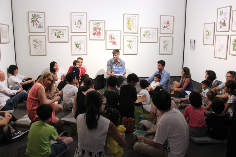 James Prosek reading his book Bird, Butterfly, Eel to families in the Chantal Miller Gallery, where Sally Grace Bunker's botanical drawings are on view.