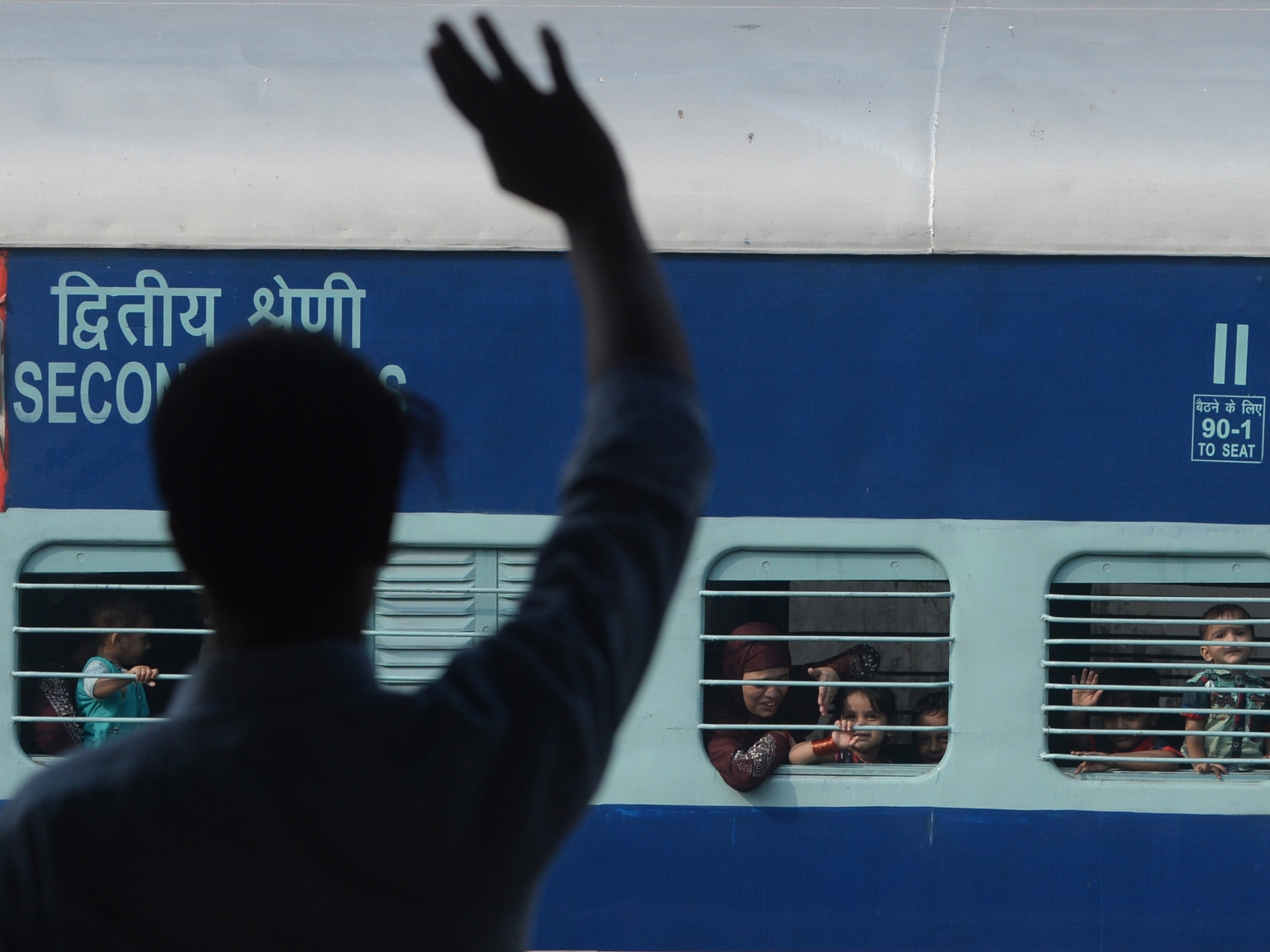 A Pakistani man waves to his Indian Muslim relatives on their departure to India via the Samjhauta Express train, also called the Friendship Express that ran between Delhi and Attari in India and Lahore in Pakistan, at the railway station in Lahore on August 8, 2019. Service was suspended in August 2019 amid worsening diplomatic tensions after India revoked the special status of the state of Jammu and Kashmir.