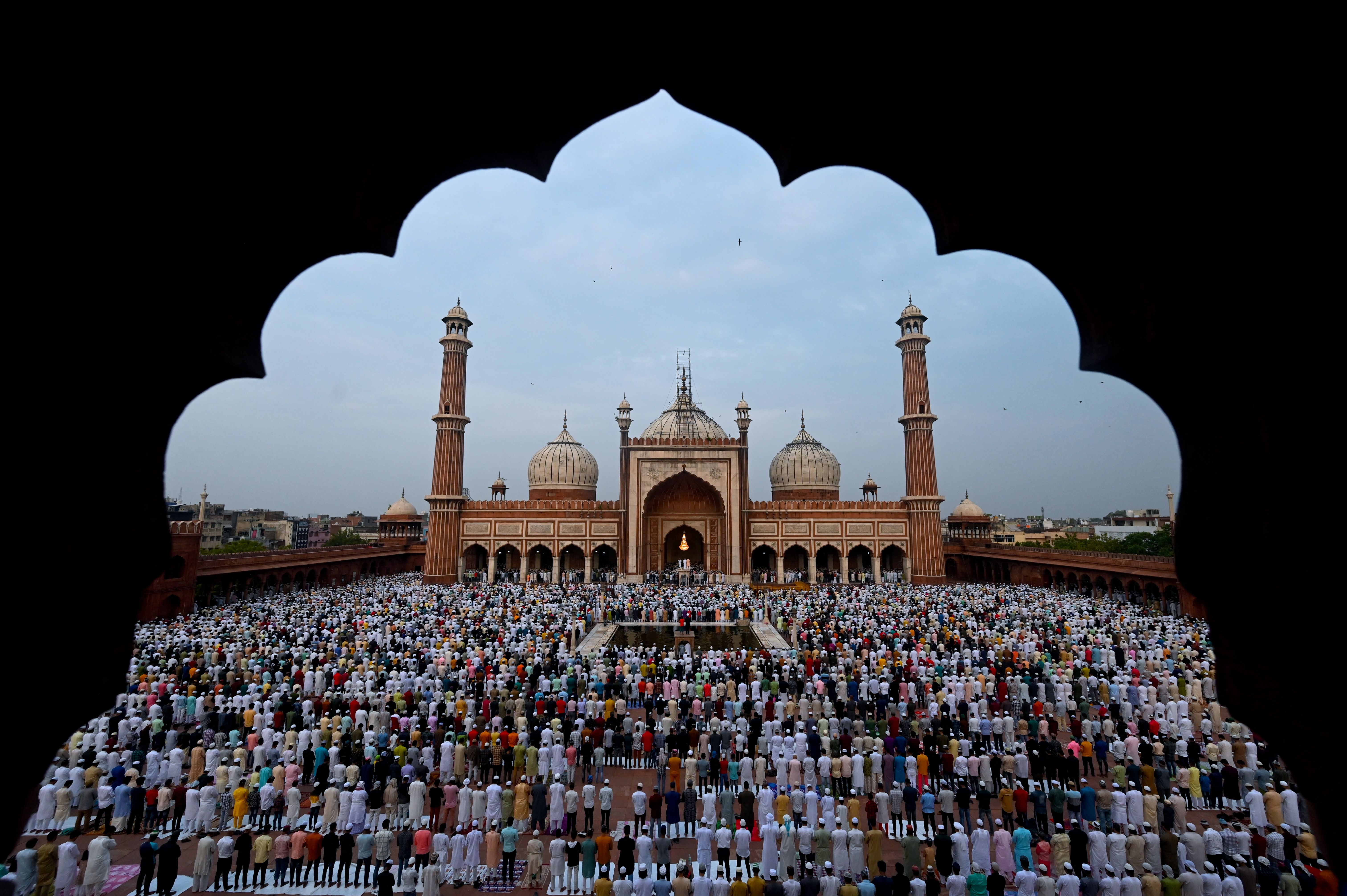 Muslim devotees offer their Eid al-Adha prayers at Jama Masjid in the old quarters of New Delhi on July 10, 2022.
