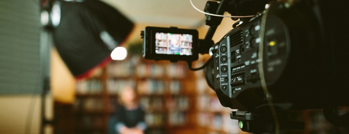 Point of view from behind a video camera shooting a scene.