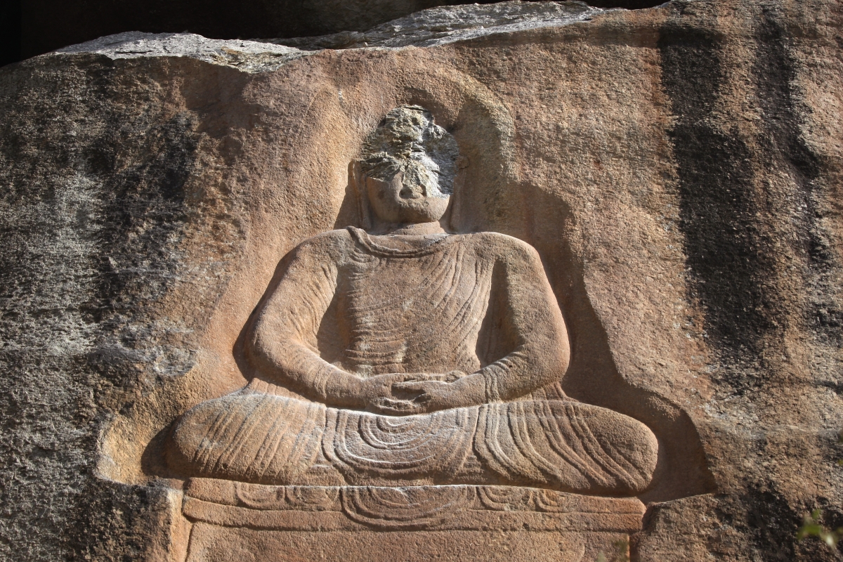 An ancient Buddha carved into into a mountainside sits defaced on Oct. 10, 2007 after Islamic extremists attacked the historic relic at Jehanabad in the Swat Valley of Pakistan. (John Moore/Getty Images)