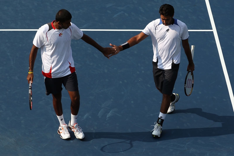 Aisam-ul-haq Qureshi (R) of Pakistan shakes hands with teammate Rohan Bopanna of India after defeating Bob Bryan and teammate Mike Bryan of the USA 7-6(8),7-5 during their quarterfinal match on day 5 of the Legg Mason Tennis Classic on August 6, 2010 in Washington, DC. (Streeter Lecka/Getty Images)