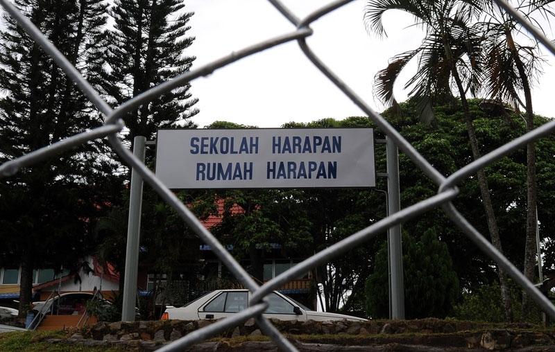 A freshly painted sign-board reads 'School of hope and 