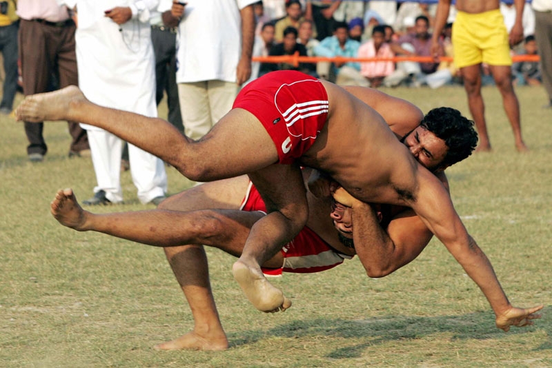 An Indian kabbadi player (L) is brought to the ground during the 2008 Sri Guru Gobind Singh Kabaddi Series in Gopalpur Majwind village, some 25 kms from Amritsar on November 9, 2008. (Narinder Nanu/AFP/Getty Images) 