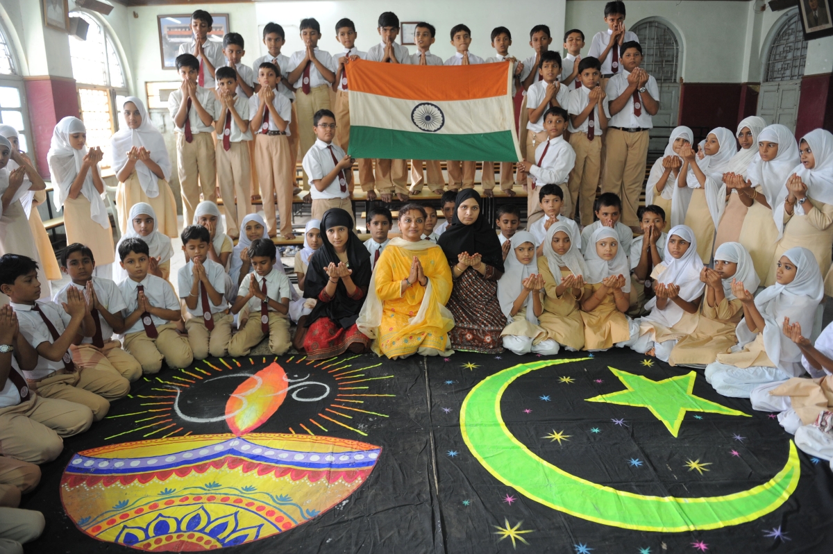 Students and teachers from the Anjuman-E-Islam school pose with Hindu and Islamic religious designs as they pray for a peaceful solution to the Ayodhya Ram Mandir and Babri Masjid issue in Ahmedabad on September 23, 2010. (Sam Panthaky/AFP/Getty Images)