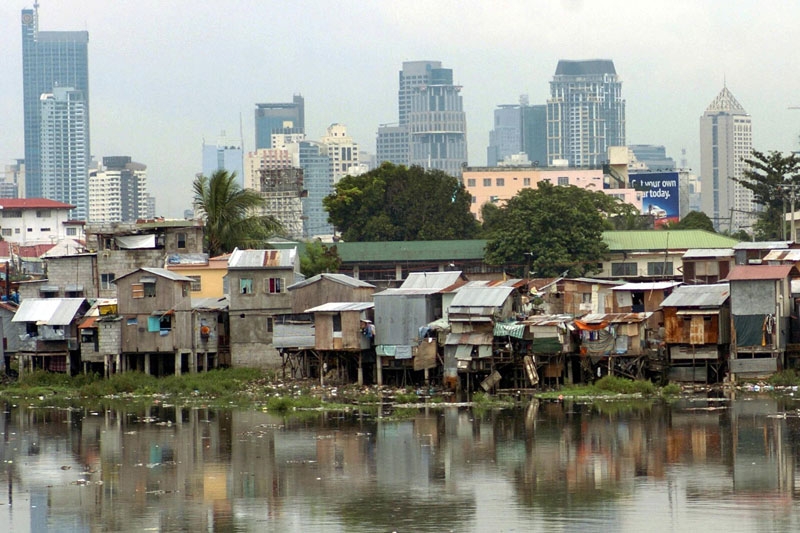 This image contrasting Manila's financial district with a squatter colony on the banks of the Pasig River (foreground) suggests some of the challenges facing Asia's cities as the effects of climate change become a reality in the 21st century. (Joel Nito/AFP/Getty Images)