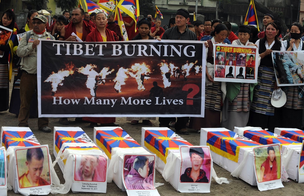Tibetans offer prayers near mock coffins to represent the victims self-immolation during a rally in Siliguri, in the Indian state of West Bengal, on February 8, 2012. China said February 7 it would 'resolutely crack down' on any attempts to instigate violence in Tibetan-inhabited areas, where authorities have launched a deadly clampdown on protesters. (Diptendu Dutta/AFP/Getty Images)