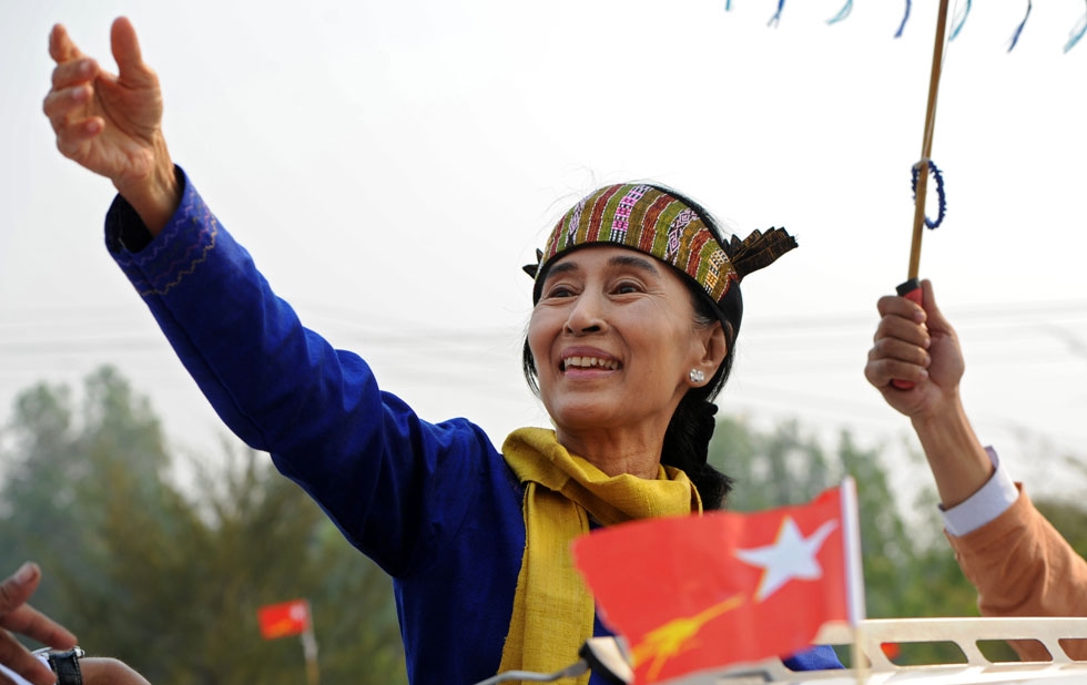 Myanmar democracy campaigner Aung San Suu Kyi greets her supporters wearing a traditional costume as she leaves after her speech in Lashio, the northern Shan state, on March 17, 2012. (Soe Than Win/AFP/Getty Images)