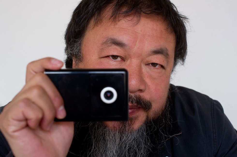Artist Ai Weiwei holds a webcam that he was reportedly ordered by Chinese police to disconnect, at his home in Beijing on April 5, 2012. (Ed Jones/AFP/Getty Images)