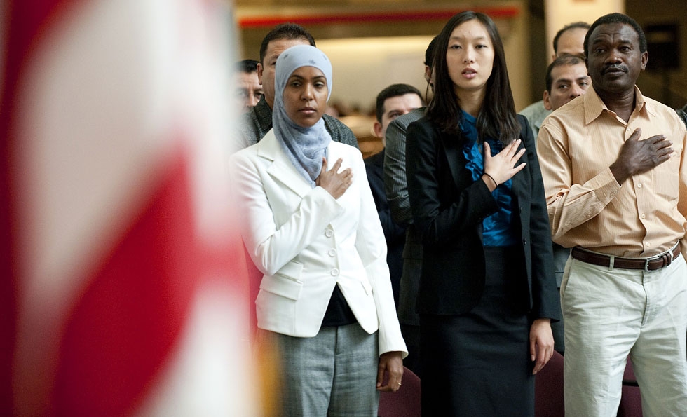A group of newly natualized U.S. citizens say the Pledge of Allegiance after taking their Oath of Allegiance at Smithsonian's National Museum of American History in Washington, DC, on Sept. 20, 2010. (Jim Watson/AFP/Getty Images)