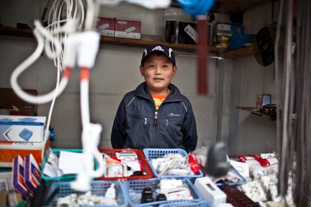 A young Kyrgyz boy mans his father's hardware shop in Osh Bazaar. (Sue Anne Tay)