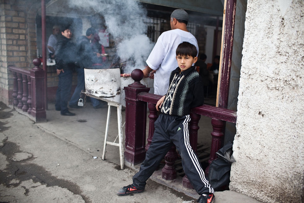A young Kyrgyz boy hangs out in front of a cafe. (Sue Anne Tay)