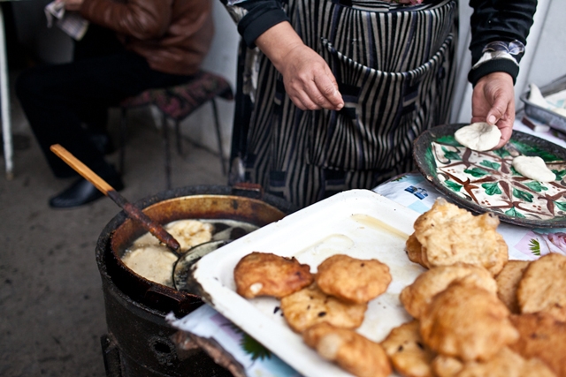 Somsa, a popular Kyrgyz fried snack, sells briskly in the bazaar. (Sue Anne Tay)