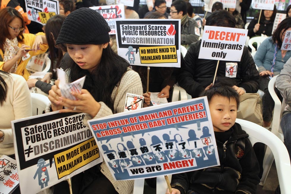 Hong Kong women hold placards during a demonstration in Hong Kong to oppose the growing number of mainland Chinese women giving birth in the city on January 15, 2012. (Joyce Woo/AFP/Getty Images)