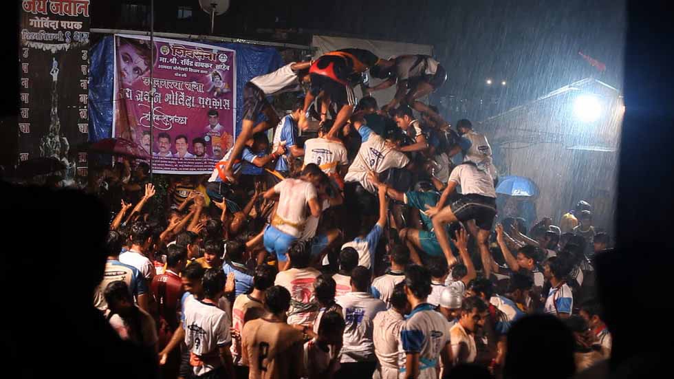 Rain or shine, this Indian team works hard to perfect its human tower. From the movie "The Human Tower." (Goldcrest Films International)
