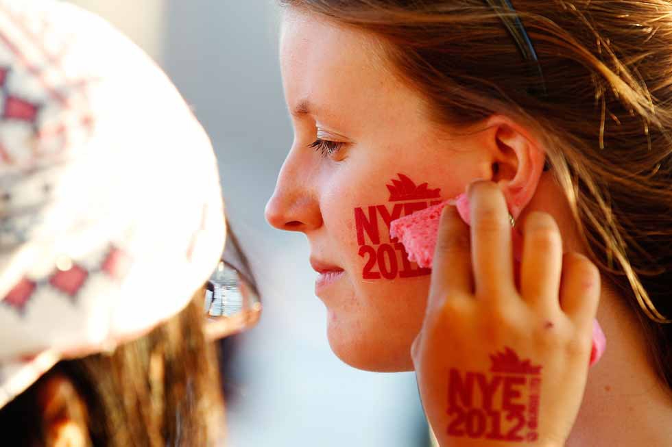 A woman receives a New Year's-themed sticker before New Year's Eve celebrations on Sydney Harbour in Sydney, Australia  on December 31, 2012. (Brendon Thorne/Getty Images)