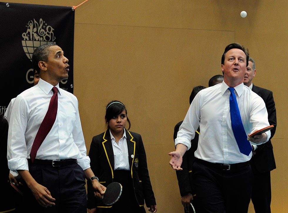 U.S. President Barack Obama and British Prime Minister David Cameron play table tennis with students of the Globe Academy school in London, England on May 24, 2011. (Paul Hackett/AFP/Getty Images) 