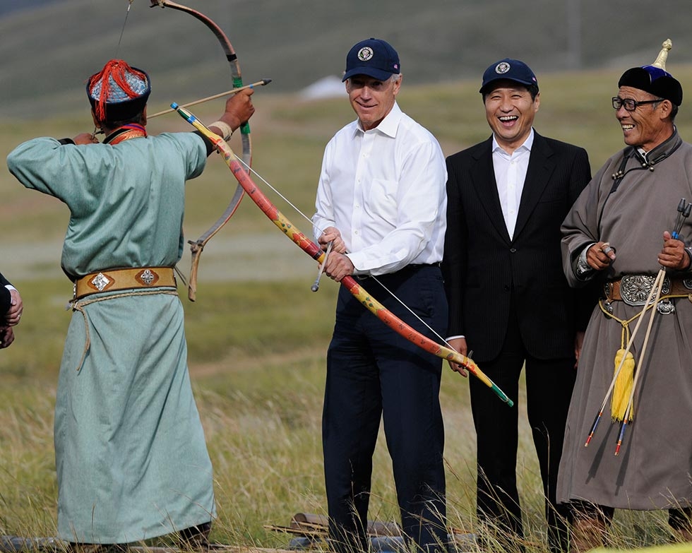 U.S. Vice President Joe Biden tries his hand at archery as Mongolian Prime Minister Sukhbaatar Batbold laughs during a mini-Naadam (traditional festival) staged in Biden's honor in Ulan Bator, Mongolia on August 22, 2011. (Goh Chai Hin/AFP/Getty Images)