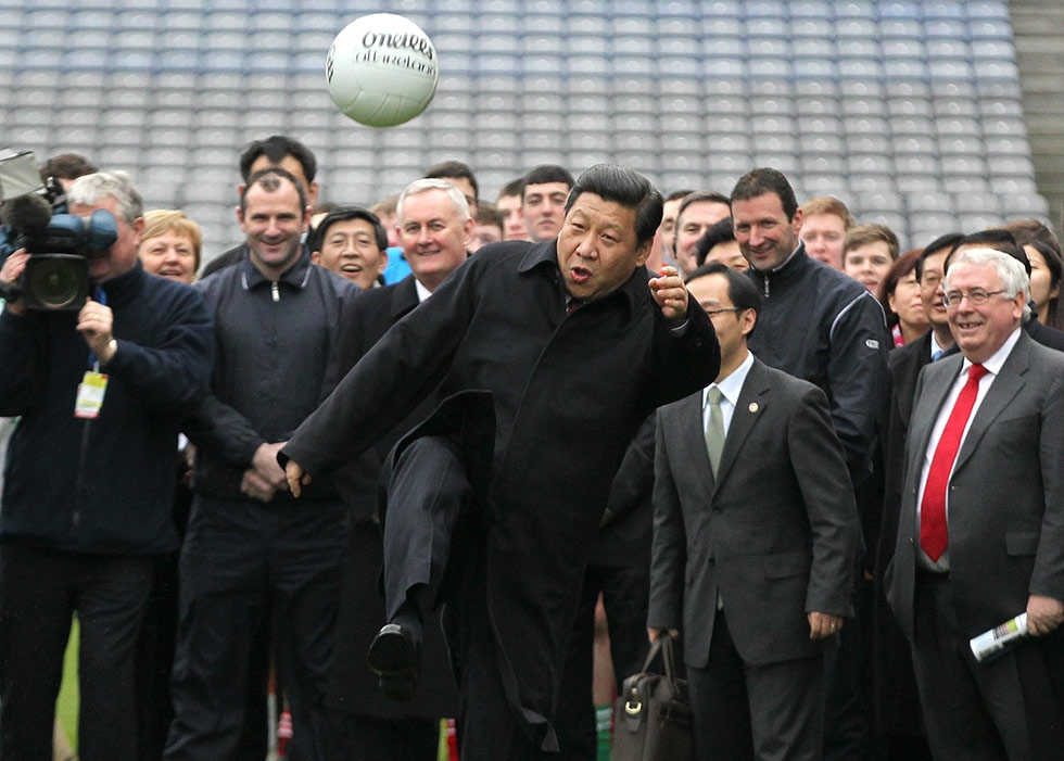 Then-Vice President (and current President) of China Xi Jinping kicks a Gaelic football as he visits Croke Park in Dublin, Ireland on February 19, 2012. (Peter Muhly/AFP/Getty Images) 

