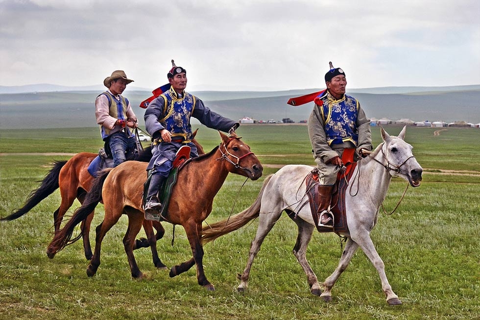 Horse races happen across the Mongolian pastureland during the three-day festival. (scott.presly/Flickr)