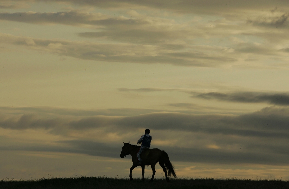 At dawn, a young Mongolian rider heads to the start of a gruelling 30km horse race during the annual Naadam festival at Khui Doloon Khudag, 40km from Ulaanbaatar. (Peter Parks/AFP/Getty Images)