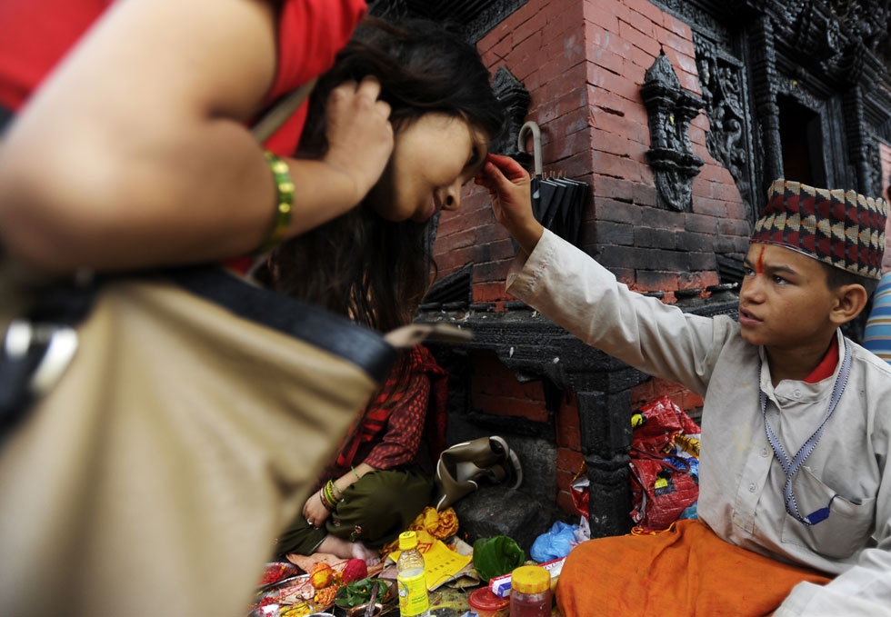 Further tika blessings for devotees at the Pashupatinath Temple in Kathmandu on July 22, 2013. (Prakash Mathema/AFP/Getty Images)