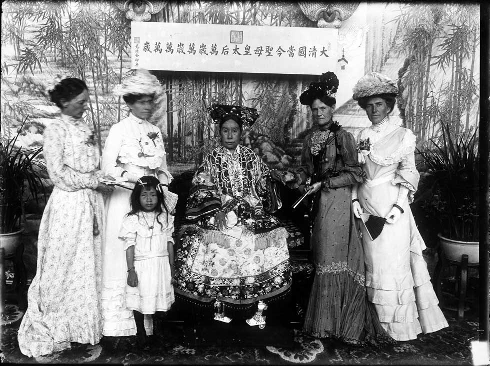 Sarah Conger (2nd R), wife of the U.S. Minister to China (1898-1905), holding hands with Empress Cixi (C) and flanked by the other ladies of the American Legation. (Freer Sackler Gallery Archives)