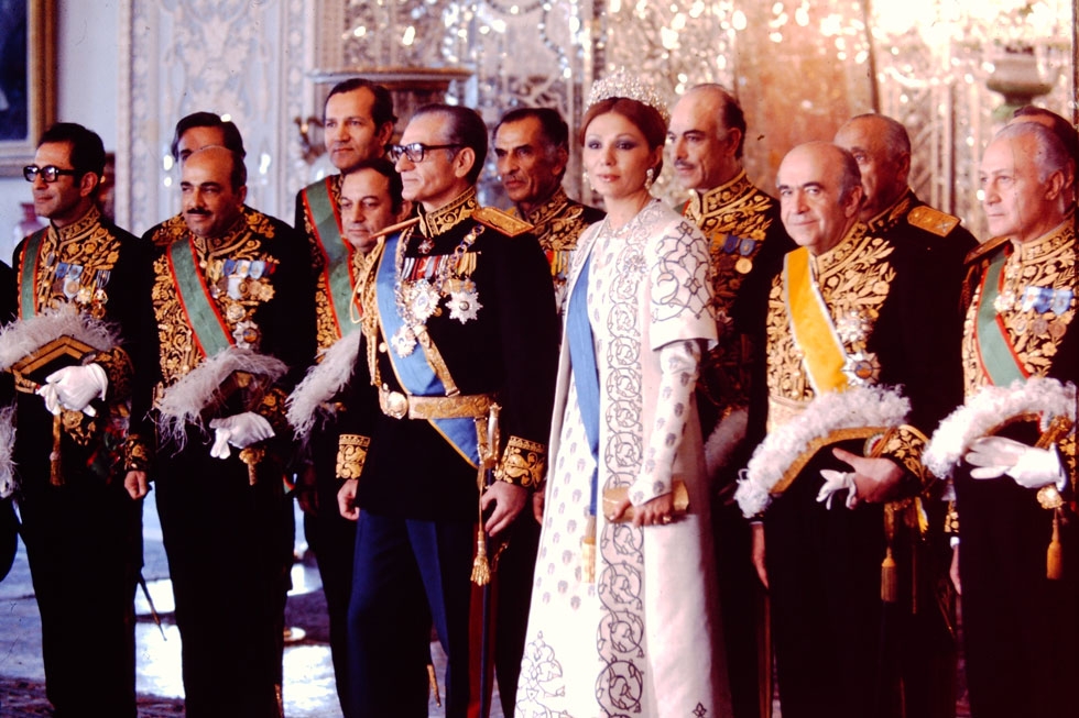 The Shahanshah Mohammad Reza Pahlavi and Shahbanu Farah Pahlavi at a court reception surrounded by the Shah's ministers of state. 