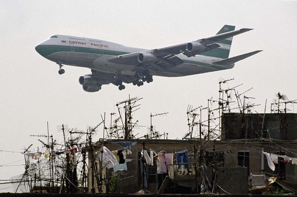 A plane flies over Kowloon Walled City en route to Kai Tak Airport, approximately four blocks away. (Greg Girard)