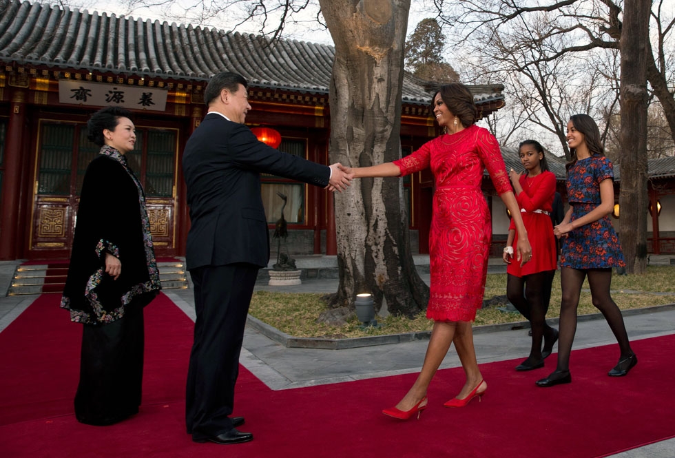 Michelle Obama, with her daughters Malia (R) and Sasha (2nd R), greets Chinese President Xi Jinping and his wife Peng Liyuan (L) in front of the Diaoyutai State guest house in Beijing on March 21, 2014. (Andy Wong-Pool/Getty Images) 